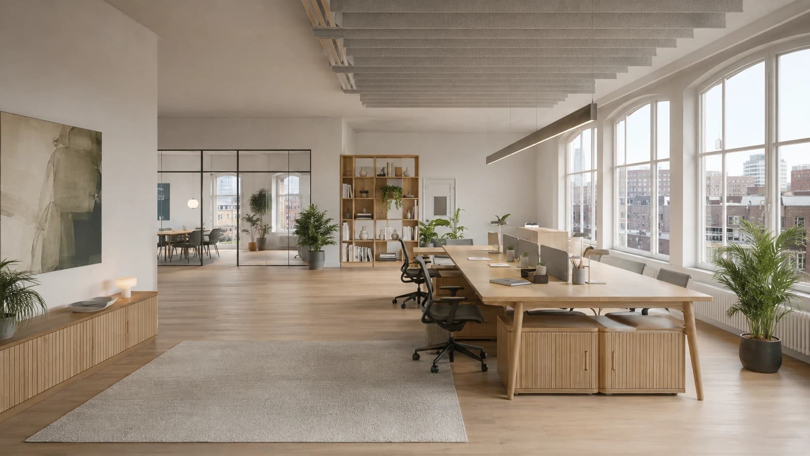 Open floor plan with plenty of daylight, a bookshelf and a quiet seating area for informal meetings.